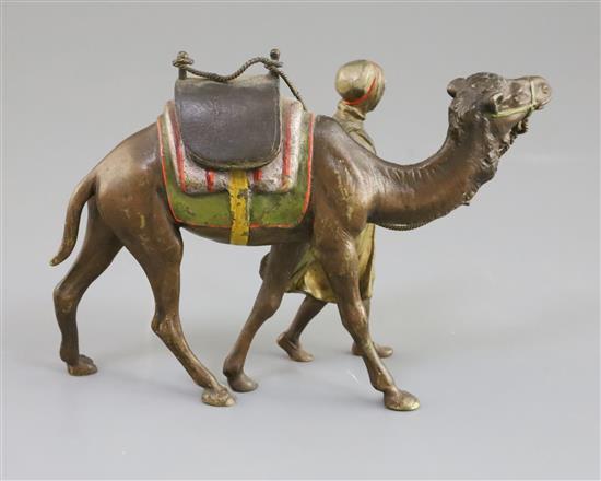 A late 19th / early 20th century Austrian cold painted bronze model of an Arab warrior walking alongside his camel, 6in.